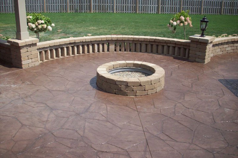 outdoor firepit, stone wall, stamped concrete