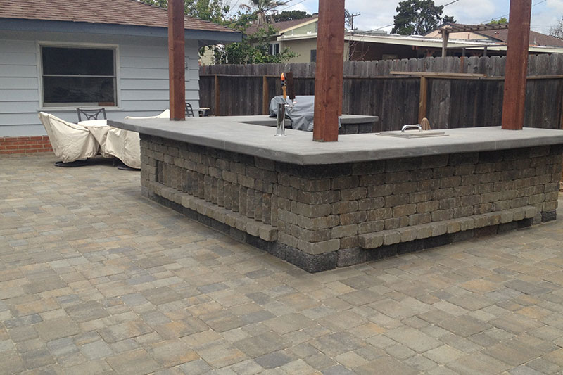 Outdoor kitchen with counter and paver patio