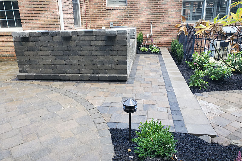 Construction phase of outdoor kitchen with paver patio