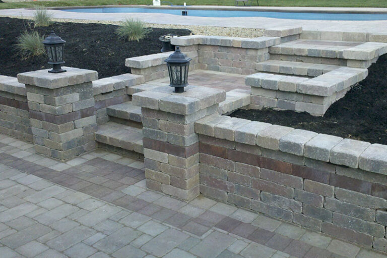 retaining wall, stone pillar with lighting, stone steps, paver patio